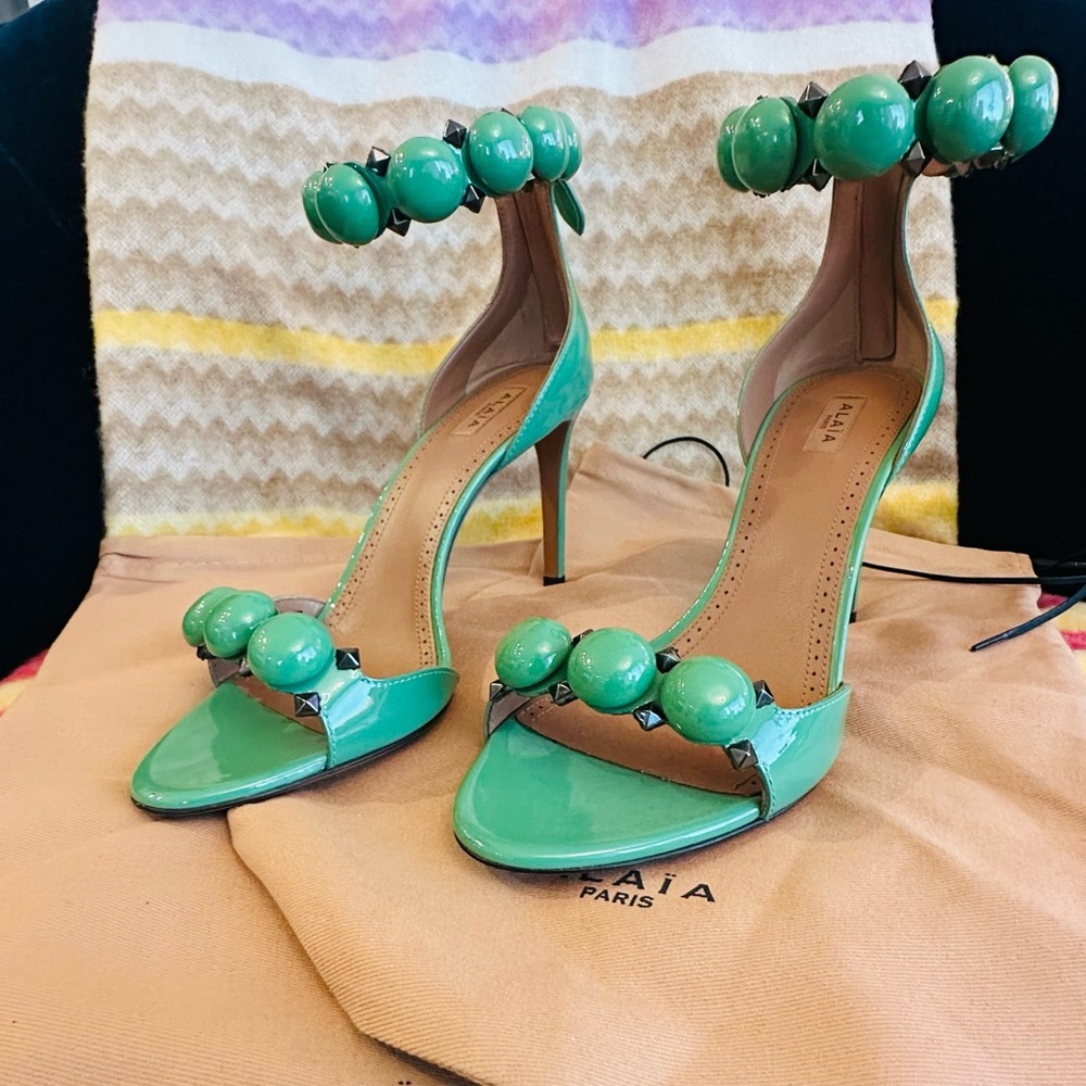 ALAIA LA BOMBE STUDDED PATENT LEATHER SANDALS